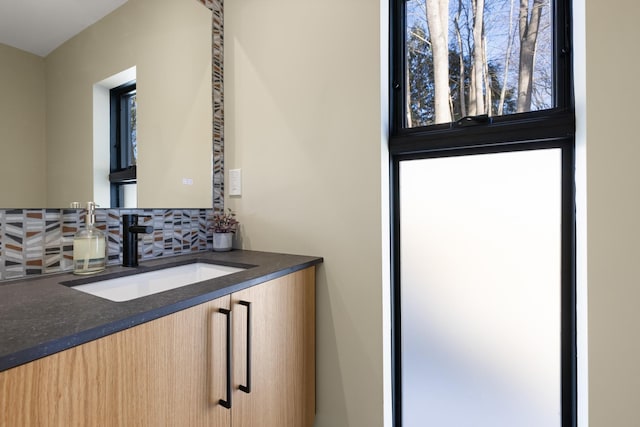 bathroom with tasteful backsplash and vanity