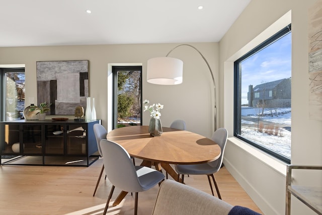 dining space featuring plenty of natural light and light wood-type flooring