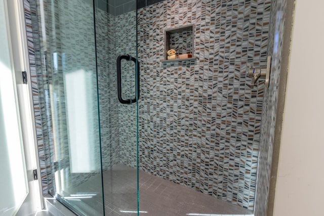 bathroom with a shower with shower door