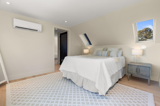 bedroom featuring wood-type flooring and a wall unit AC