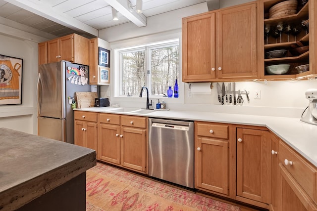 kitchen with appliances with stainless steel finishes, sink, wood ceiling, and beam ceiling