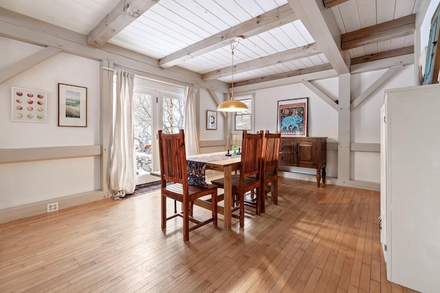 dining room with beamed ceiling, wooden ceiling, and light wood-type flooring