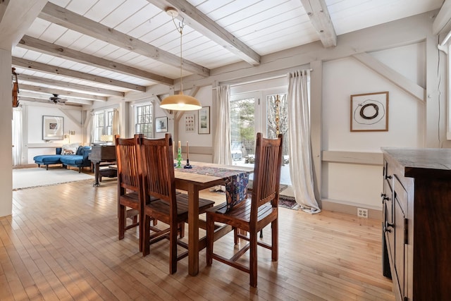 dining room featuring ceiling fan, plenty of natural light, beam ceiling, and light wood-type flooring