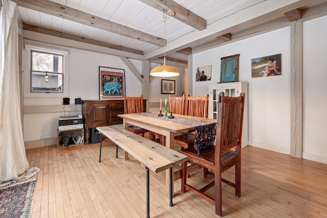 dining space with beamed ceiling, wood ceiling, and light wood-type flooring