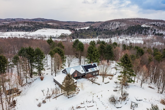 snowy aerial view with a mountain view