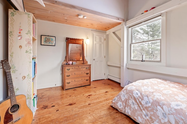 bedroom with hardwood / wood-style flooring, wood ceiling, and a baseboard heating unit