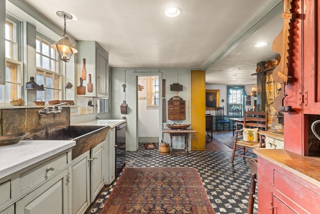 kitchen with gray cabinets, sink, a wealth of natural light, and beverage cooler