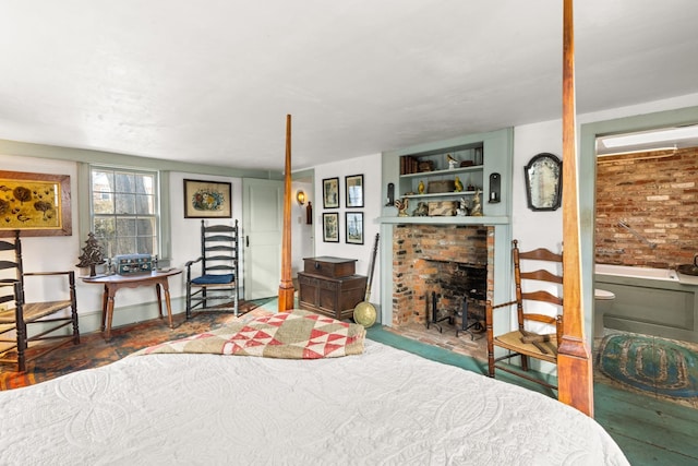 bedroom featuring brick wall and a fireplace