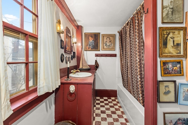 bathroom featuring vanity and shower / bath combination with curtain