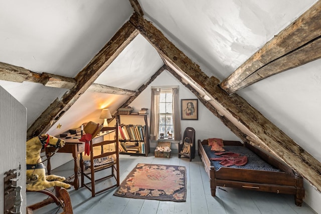 additional living space featuring vaulted ceiling with beams