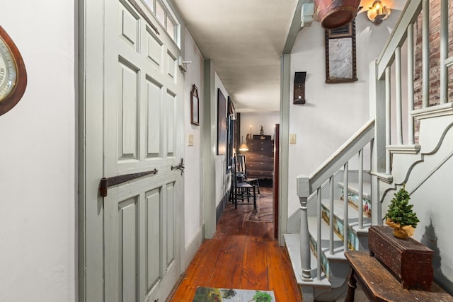 corridor with dark hardwood / wood-style flooring