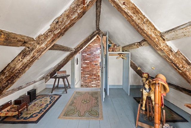 bonus room with lofted ceiling and hardwood / wood-style floors