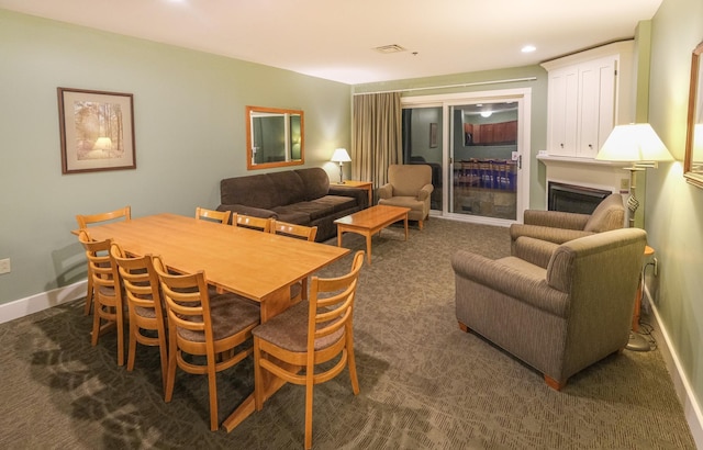 dining area with dark carpet