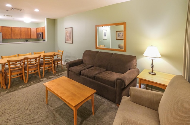 living room featuring dark colored carpet