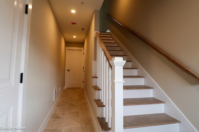 staircase featuring tile patterned floors