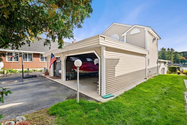 view of side of property featuring a yard and a garage