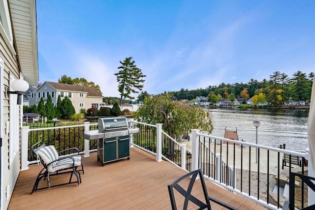 deck featuring area for grilling and a water view