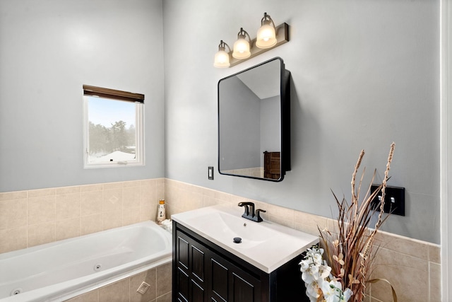 bathroom with vanity and a relaxing tiled tub