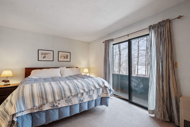 carpeted bedroom with access to outside and a textured ceiling