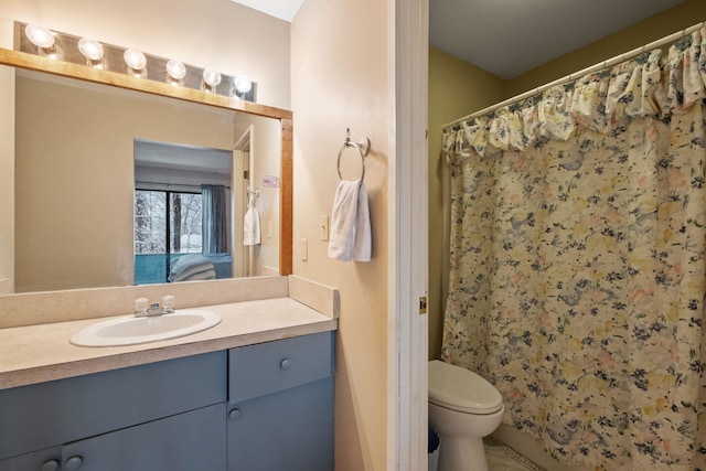 bathroom featuring vanity, toilet, and walk in shower