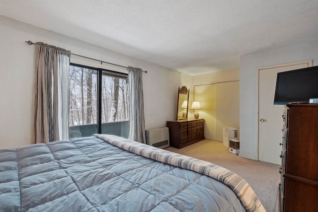 carpeted bedroom featuring a textured ceiling