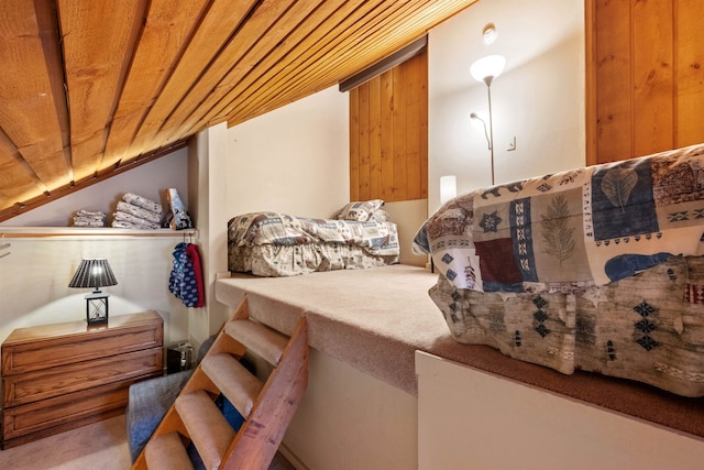 bedroom with lofted ceiling, carpet, and wooden ceiling