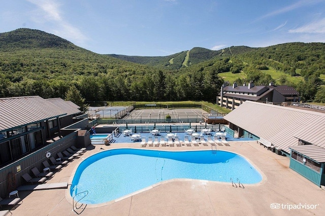 view of pool featuring a mountain view and a patio