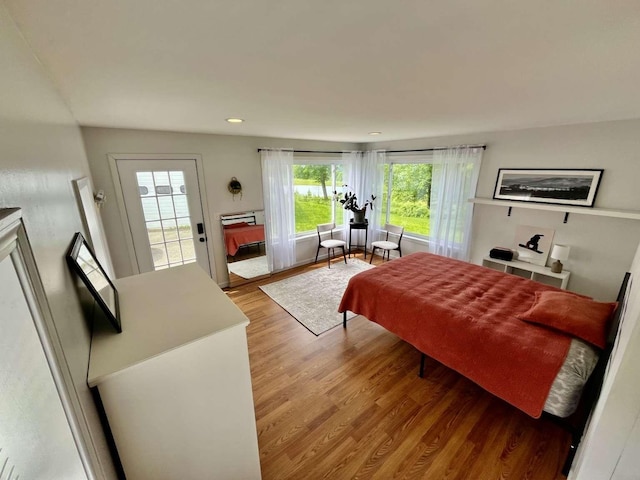 bedroom with hardwood / wood-style flooring and access to exterior