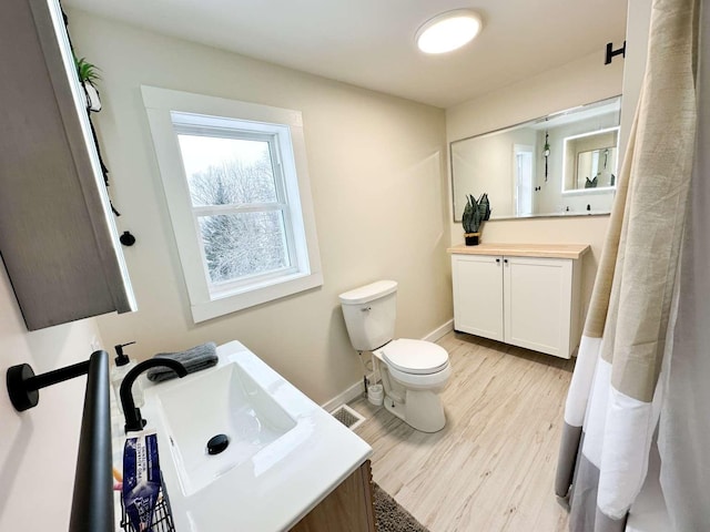 bathroom with vanity, hardwood / wood-style floors, and toilet