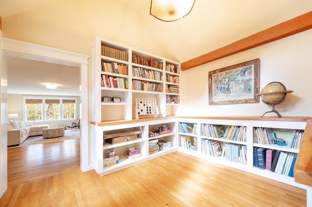 unfurnished room with wood-type flooring and lofted ceiling