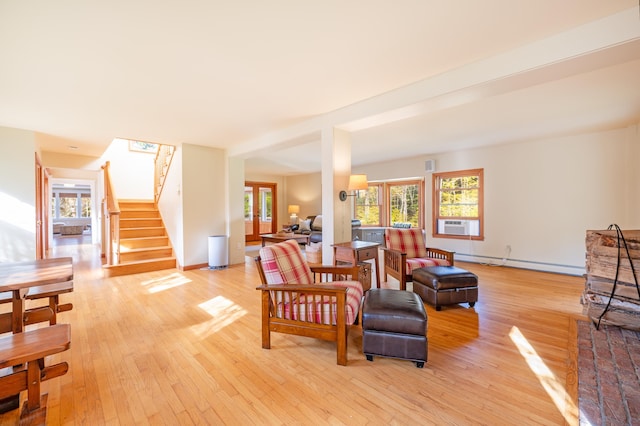 living room featuring light hardwood / wood-style flooring, cooling unit, a baseboard radiator, and french doors