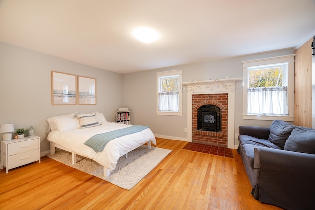 bedroom with multiple windows and light hardwood / wood-style flooring