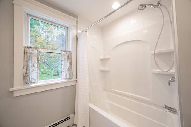 bathroom with shower / bath combo, plenty of natural light, and a baseboard radiator