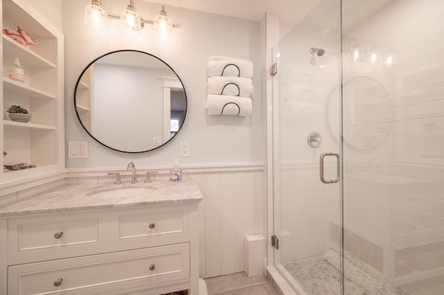 bathroom with walk in shower and vanity