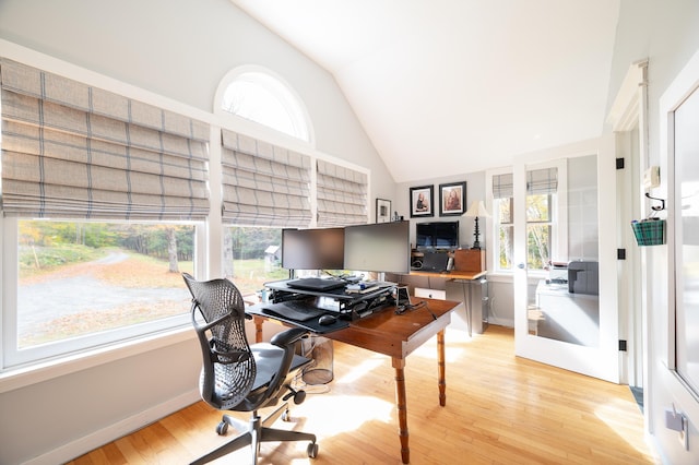 office area featuring high vaulted ceiling, a wealth of natural light, and light hardwood / wood-style floors