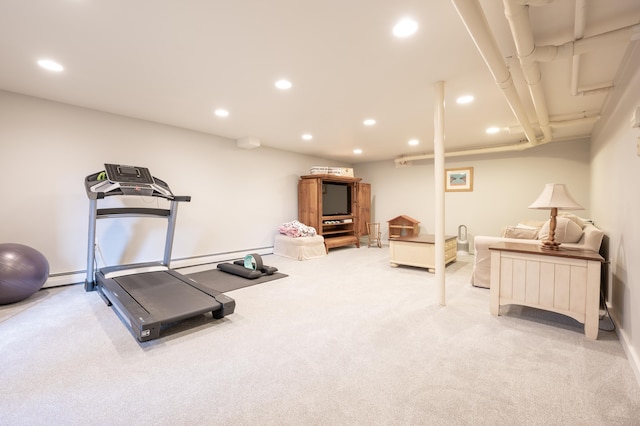 workout area featuring light carpet and a baseboard heating unit