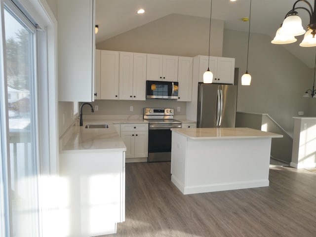 kitchen featuring sink, white cabinetry, a kitchen island, pendant lighting, and stainless steel appliances