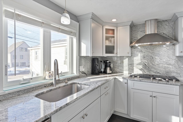 kitchen featuring white cabinetry, sink, decorative backsplash, and wall chimney exhaust hood