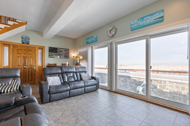 living room with light tile patterned flooring and beam ceiling