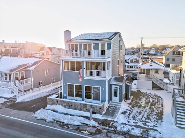 view of snow covered rear of property