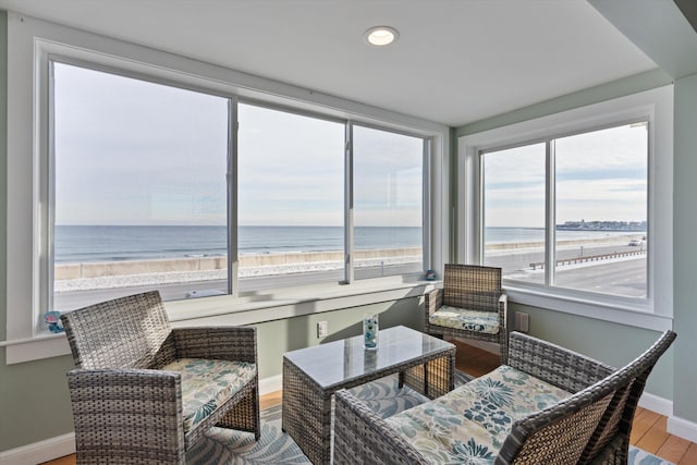 sunroom with a beach view and a water view