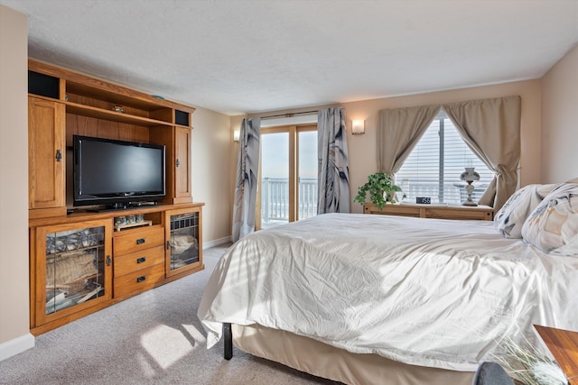 carpeted bedroom featuring access to outside