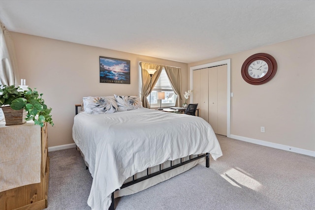 bedroom with light colored carpet and a closet