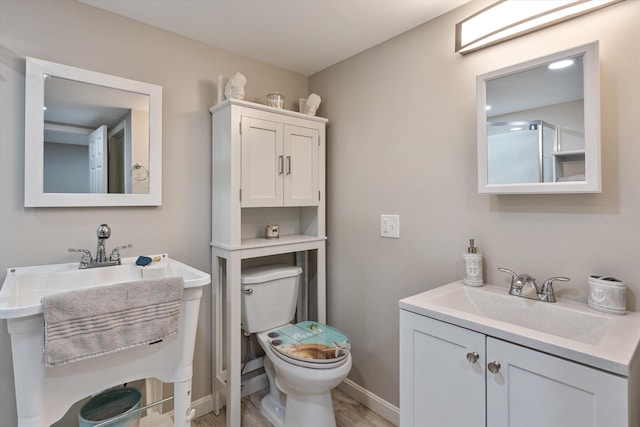 bathroom featuring hardwood / wood-style flooring, vanity, and toilet