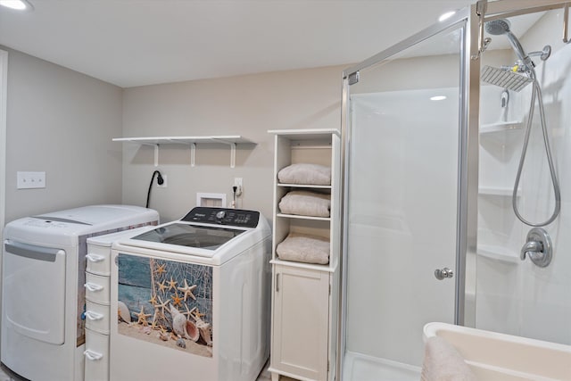 clothes washing area featuring washer and clothes dryer