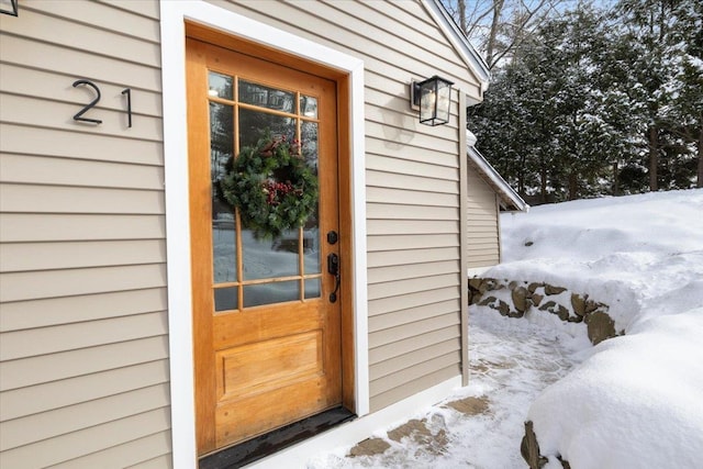 view of snow covered property entrance