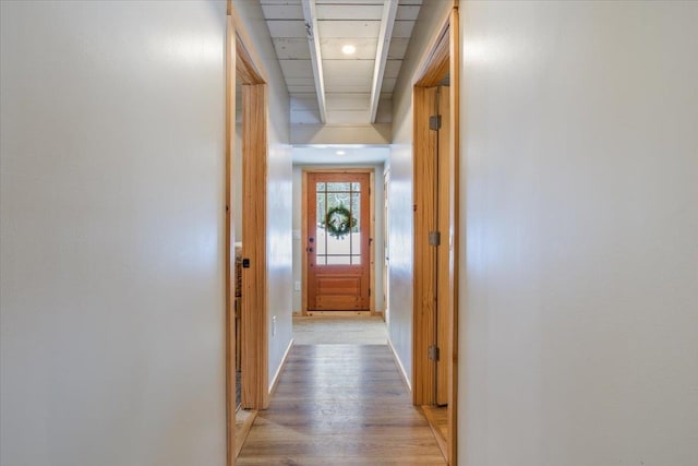 hallway with light hardwood / wood-style floors