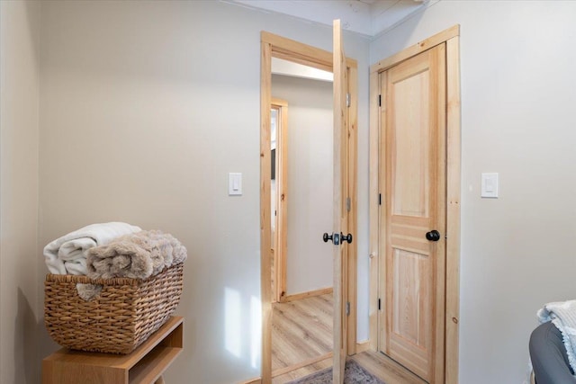 corridor with light hardwood / wood-style flooring