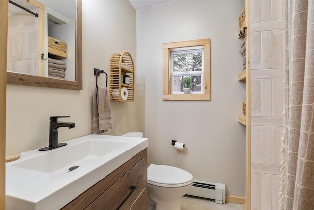 bathroom featuring baseboard heating, vanity, and toilet