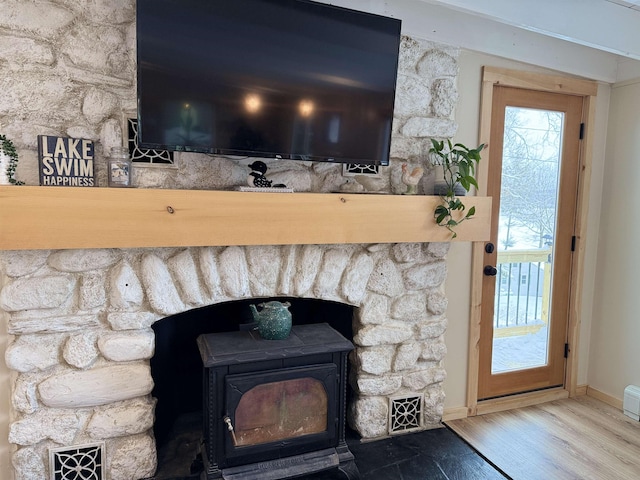 details featuring wood-type flooring and a wood stove